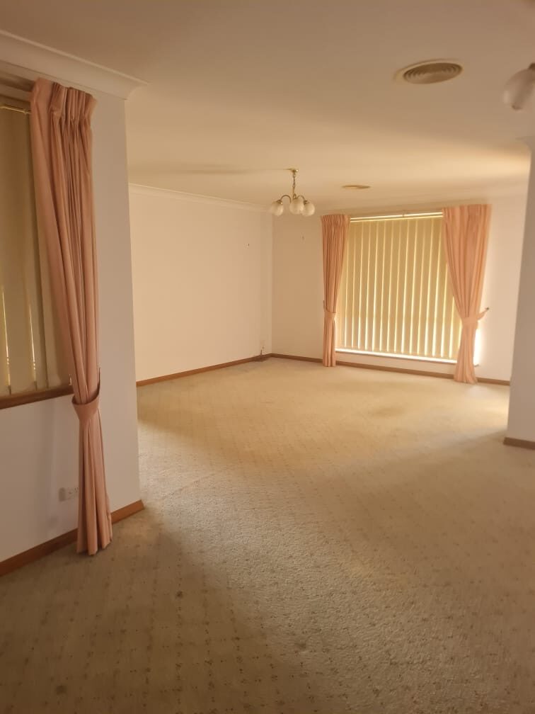 Empty lounge and dining room with carpets cleaned for handover