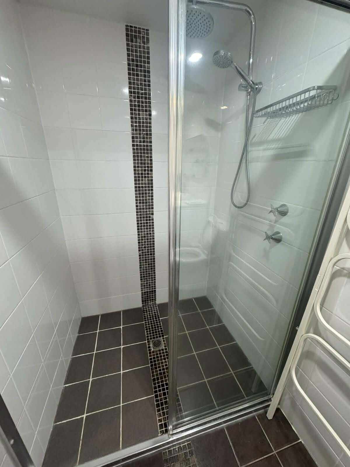 Shower recess and tiles scrubbed during a regular home clean