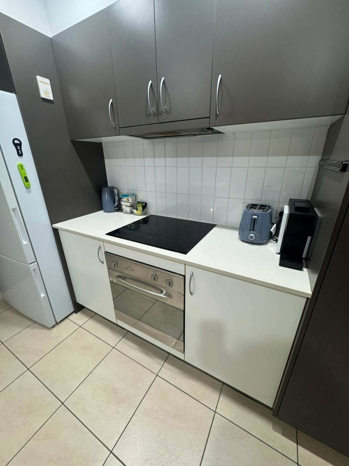 Kitchen benchtop, cooktop and oven wiped down during a residential clean