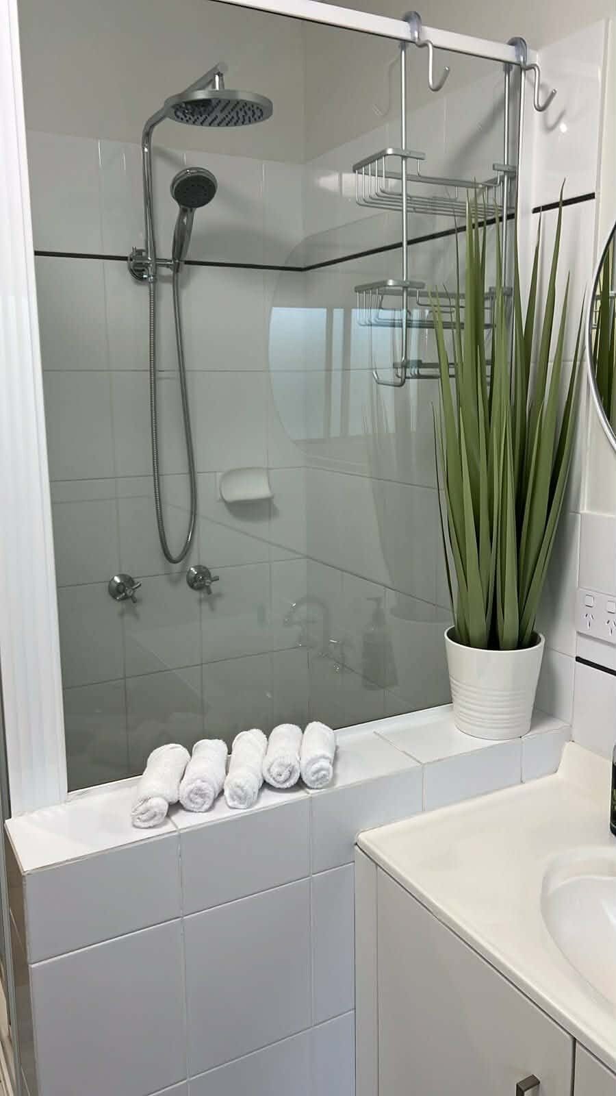 Shower cleaned with rolled towels ready for guest arrival