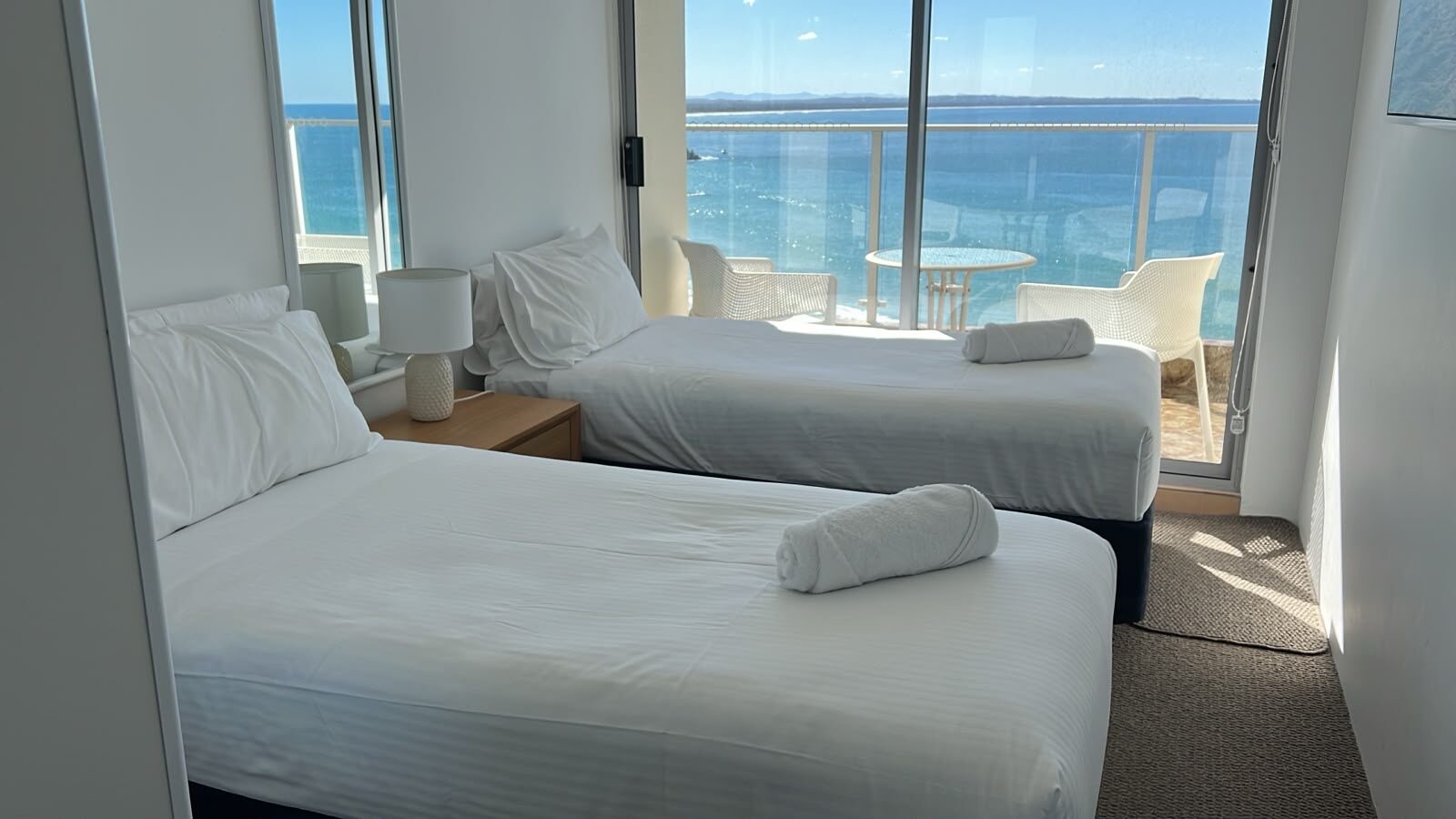 Twin bedroom with ocean views made up for Airbnb guests