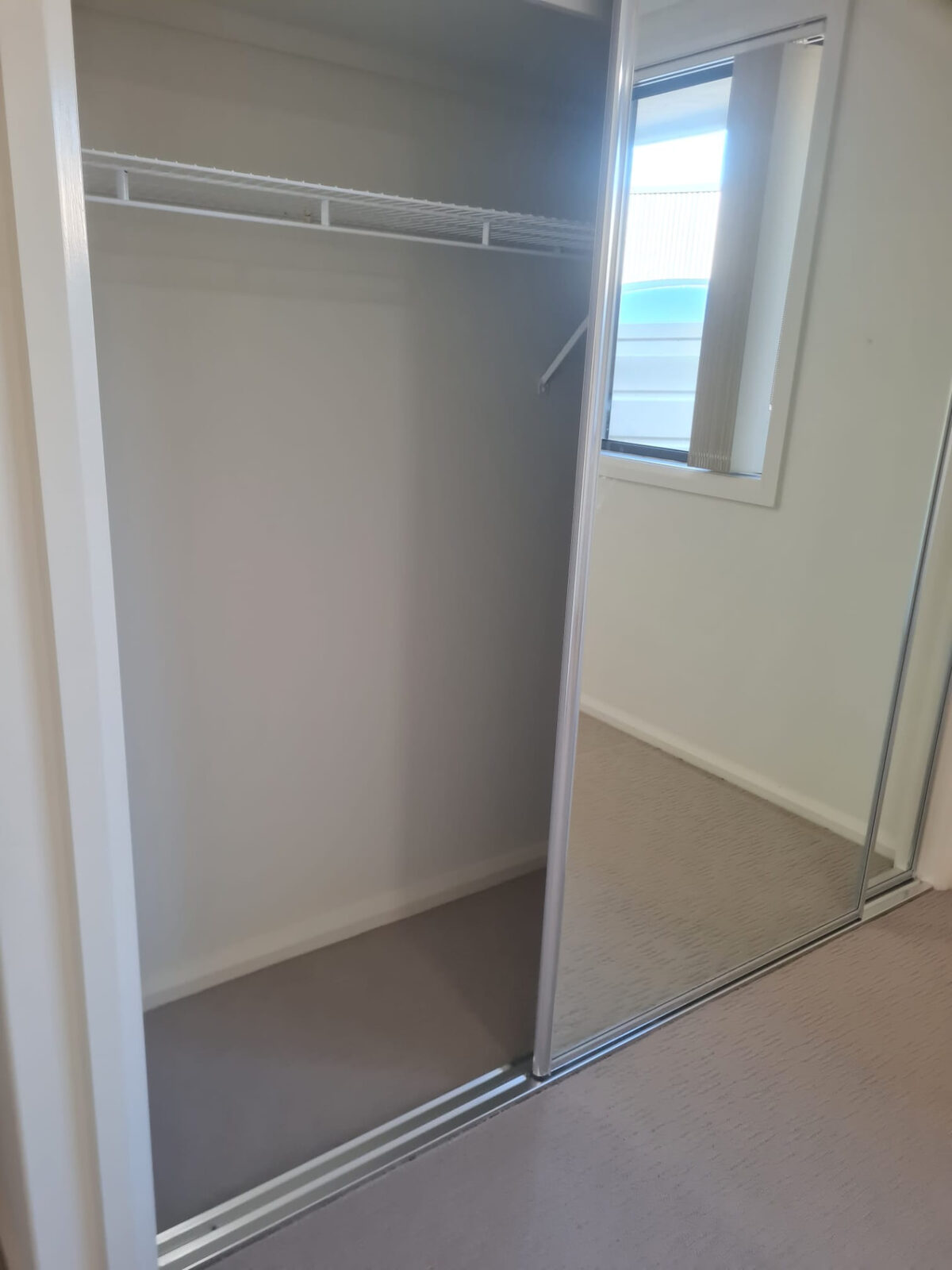 Empty mirrored wardrobe wiped out for vacate inspection