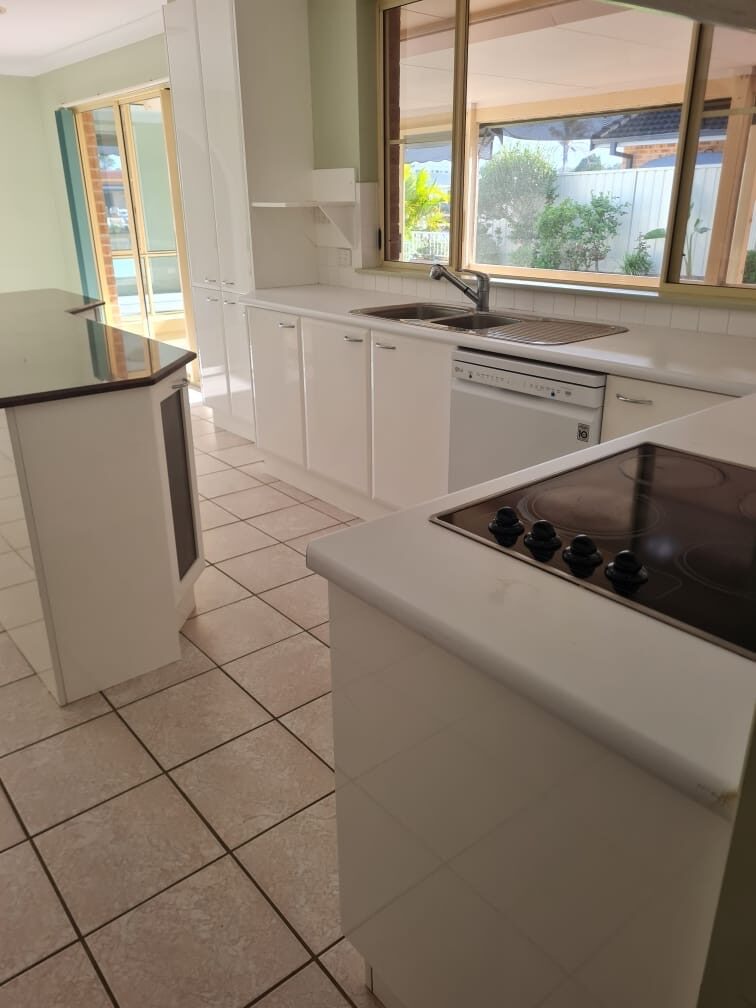 Kitchen benches, cooktop and dishwasher cleaned ready for settlement