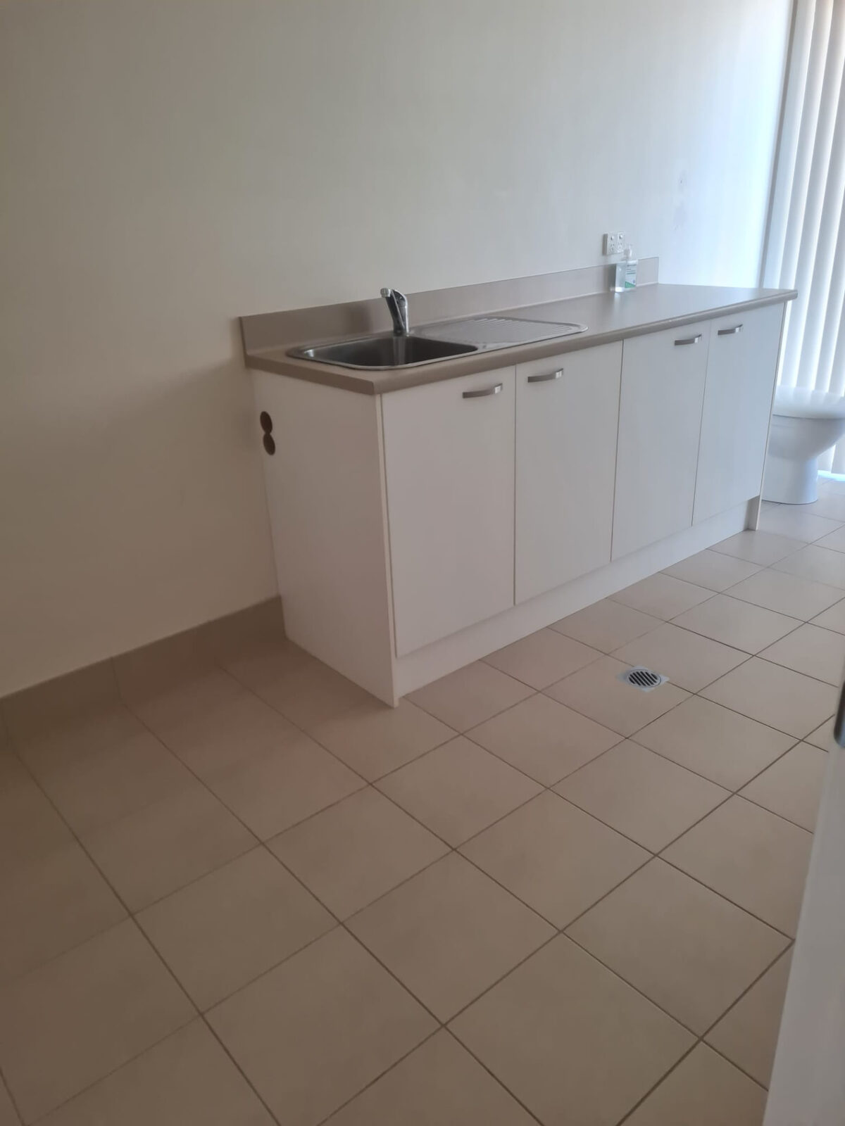 Laundry sink, cabinets and tiled floor cleaned for vacate