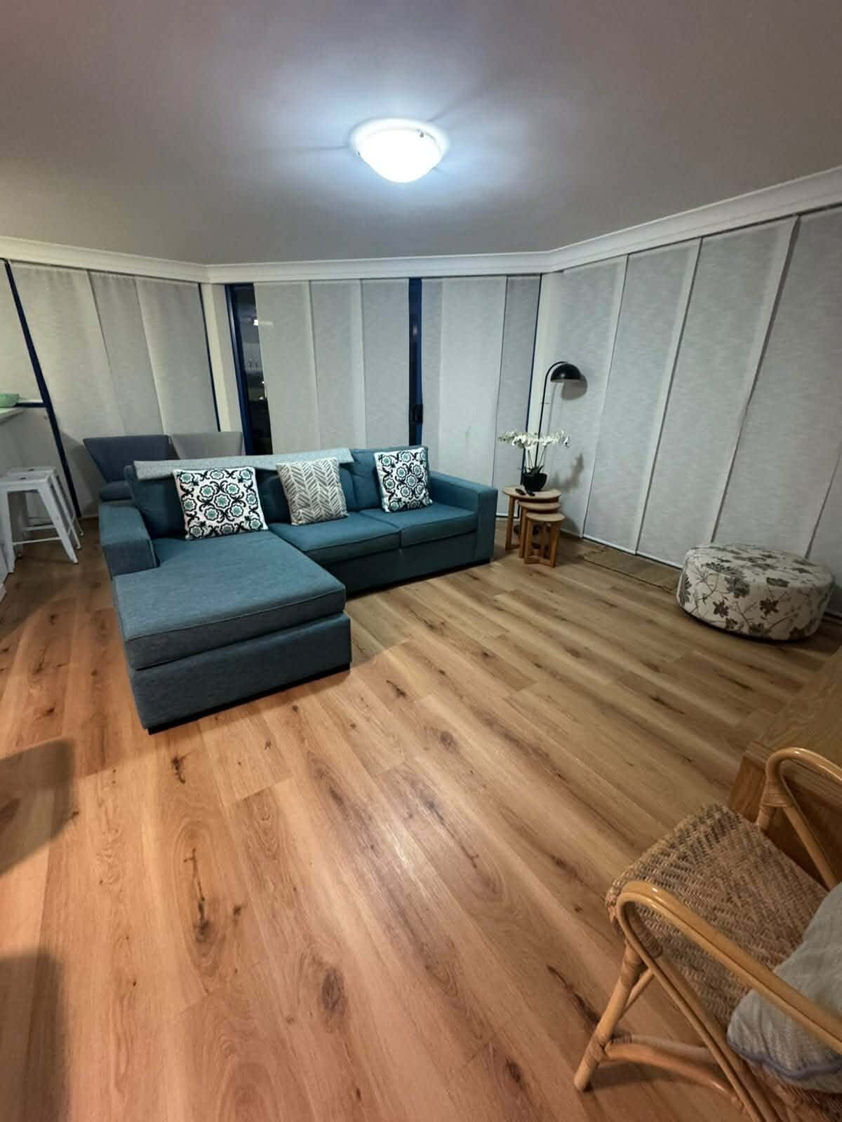 Living room with freshly mopped timber floors after a house clean