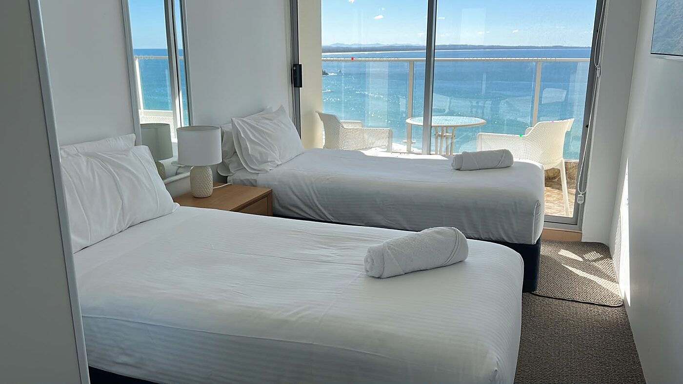 Coastal bedroom with ocean views styled and cleaned for Airbnb guests in Forster NSW